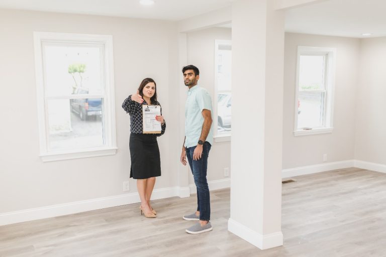 A real estate agent showing a house to a man